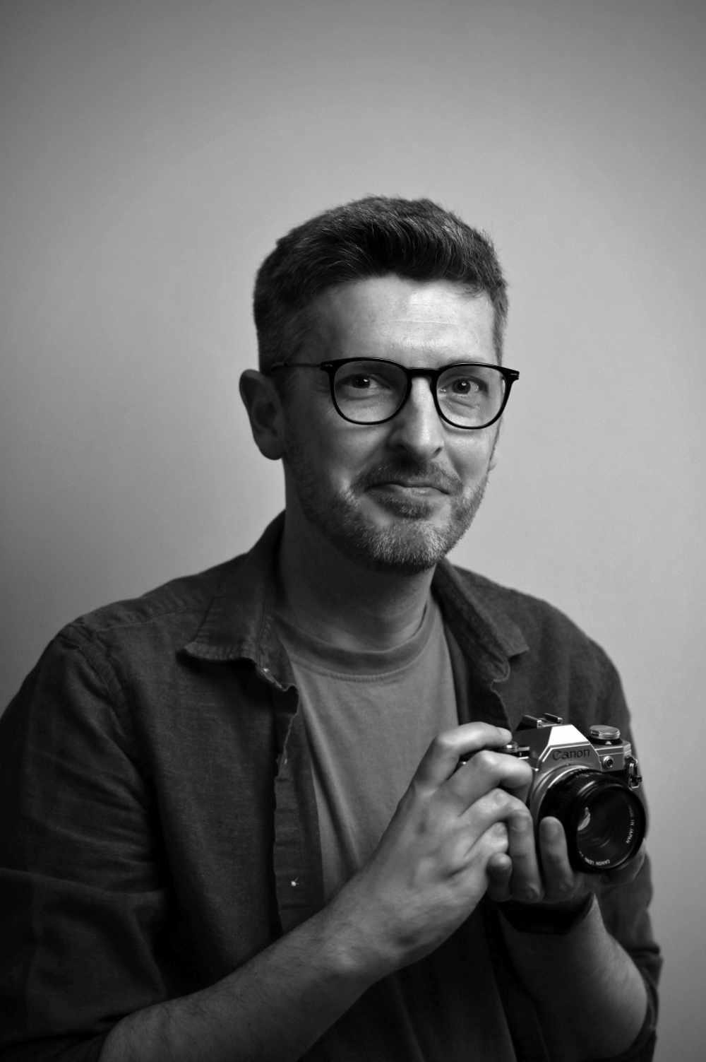 A black and white photo of me - David Mercer - holding a camera